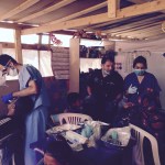 Dr working on a patient with the staff in background 