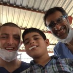 Both Dr.s' and a young boy smiling 