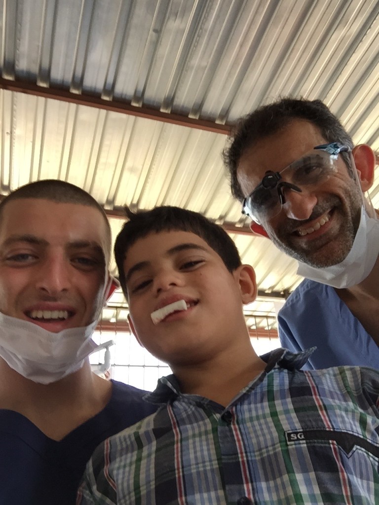 Both Dr.s' and a young boy smiling 