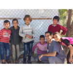 Dr with children outside by a tree