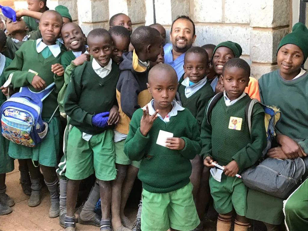 Dr. Sinha with young children in Kenya