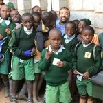 Dr. Sinha with young children in Kenya