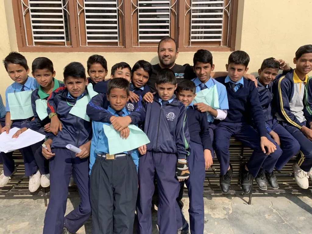 Dr. Sinha with young children in Nepal