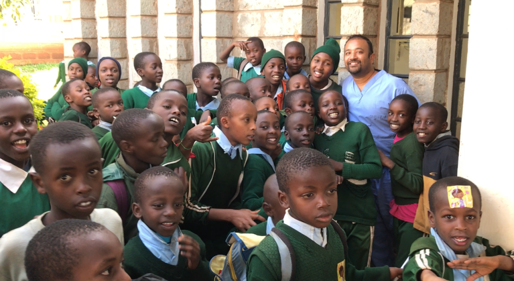 Dr. Sinha with young children in Kenya