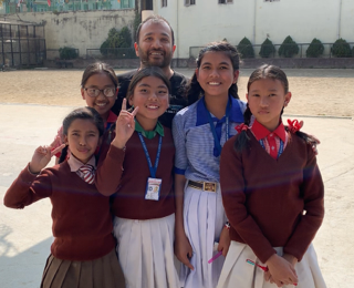 Dr. Sinha with young students