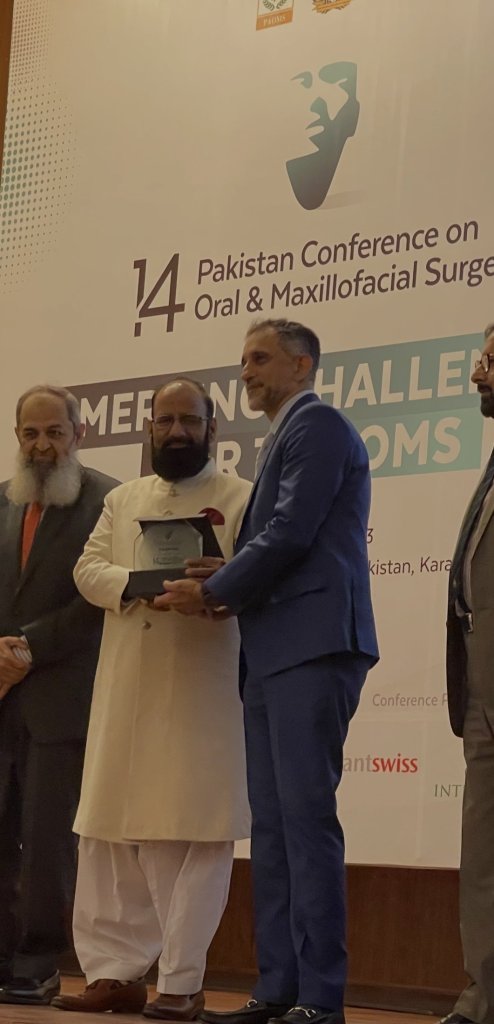 Dr. Malik getting an award